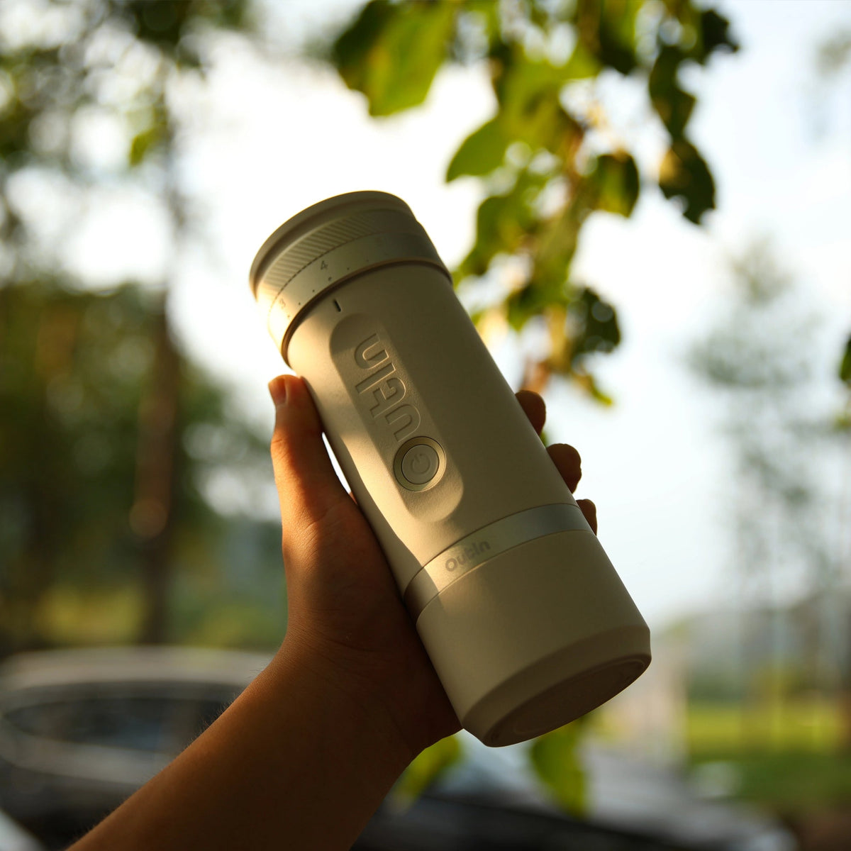 Holding the OutIn Fino grinder up against foliage
