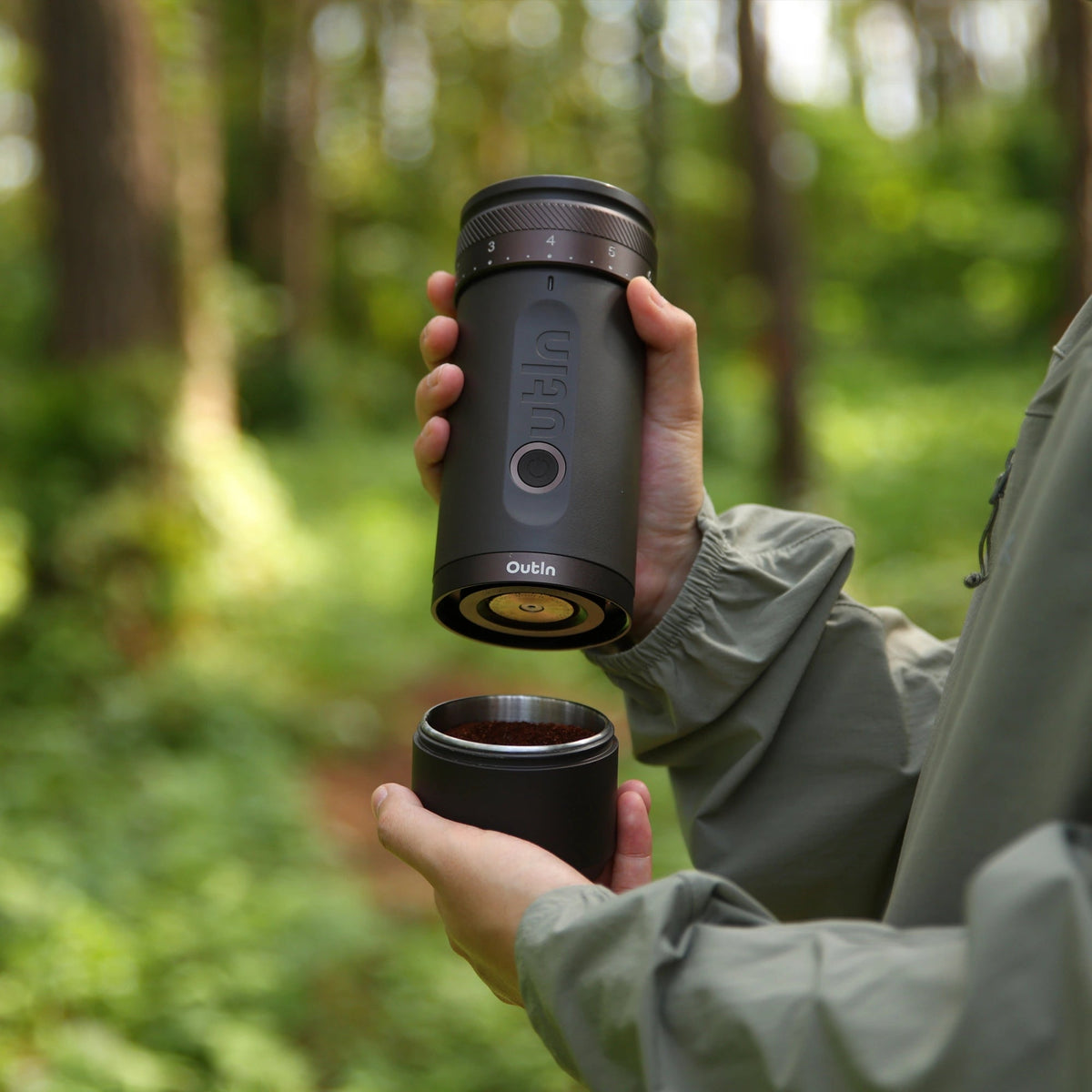 Holding the OutIn Fino grinder and grounds cup outdoors